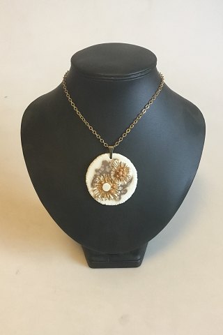Royal Copenhagen Pendant of porcelain with gold decoration. Designed by Nils 
Thorson. Sterling Silver by Anton Michelsen