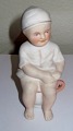 Porcelain Figurine of a little boy on the pot